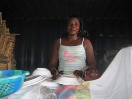 Kumba posing behind the counter at her restaurant